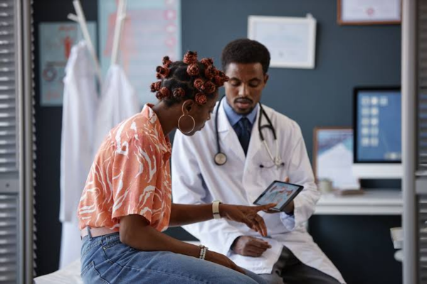 Female patient talking with a hormonal imbalance fertility specialist about diagnostic blood results in a modern clinic office